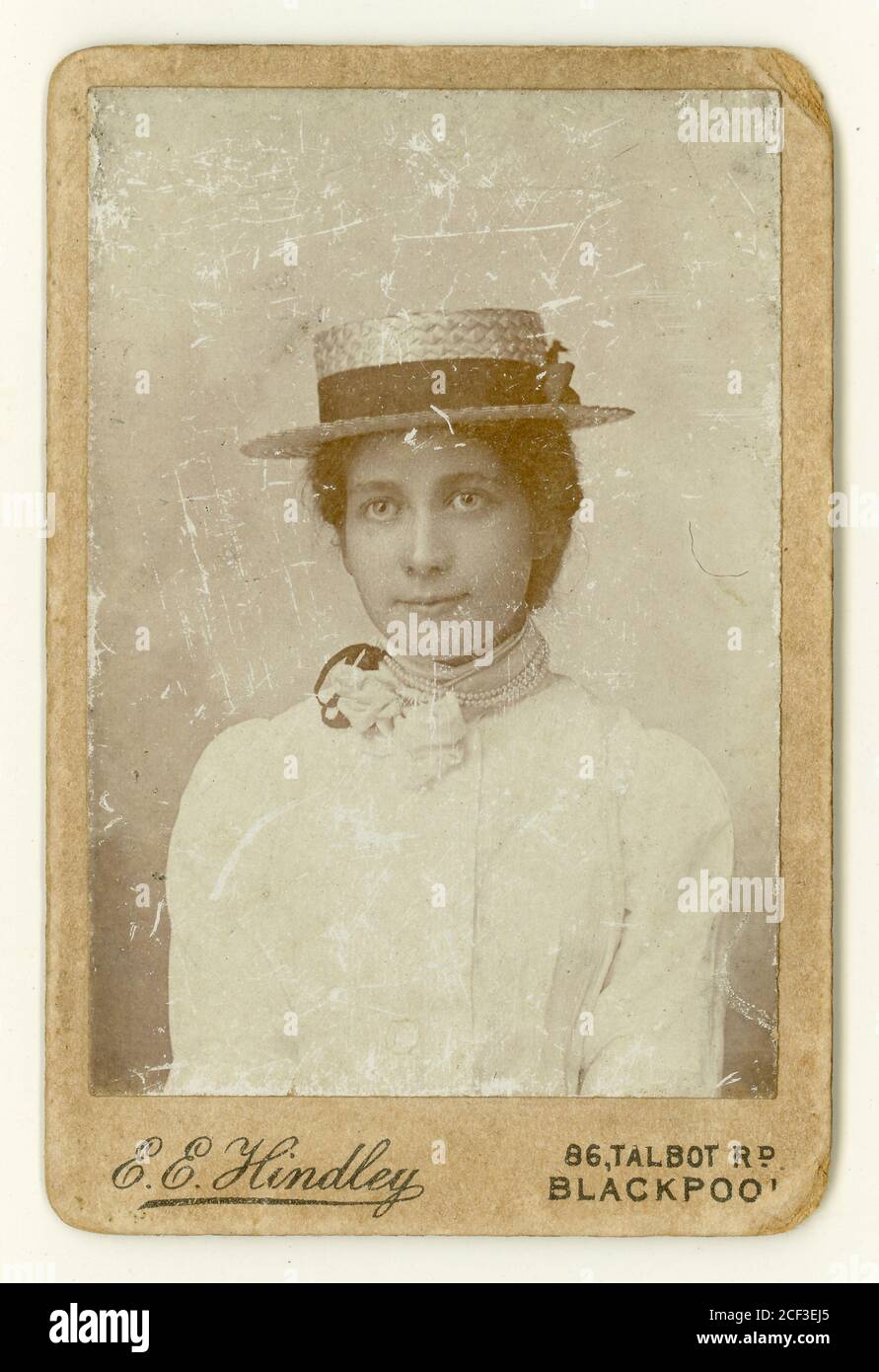 Well-worn Victorian Carte de Visite of beautiful young lady, wearing white summer dress with pearl choker and boater,on holiday in Blackpool,  by E.E. Hindley, 86 Talbot Road, Blackpool, Lancashire, U.K. circa 1885 Stock Photo