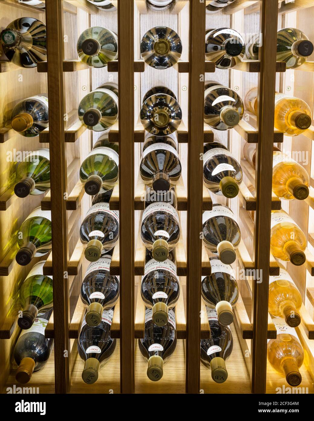 Wine bottles on shelves Stock Photo
