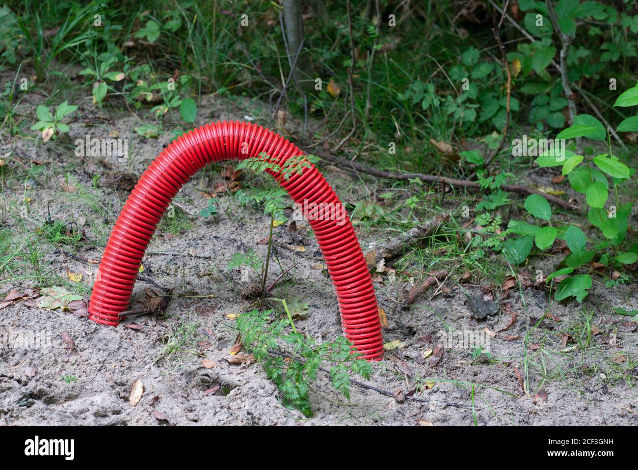 Red corrugated pipe for electric cables buried in the ground Stock ...