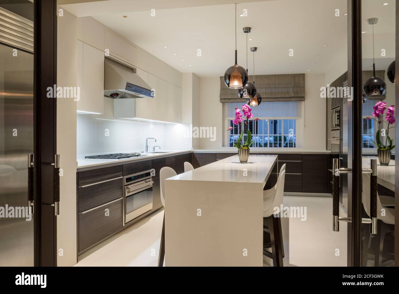 View of Modern kitchen with pendant lights Stock Photo - Alamy
