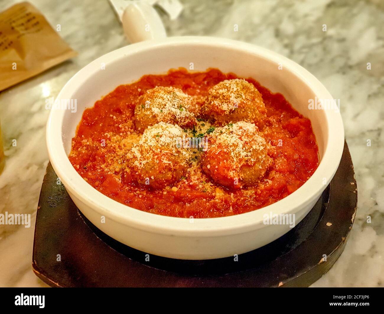 Meatball, ground meat rolled into a small ball, along with other ingredients, such as bread crumbs, minced onion, eggs, butter, and seasoning. Stock Photo