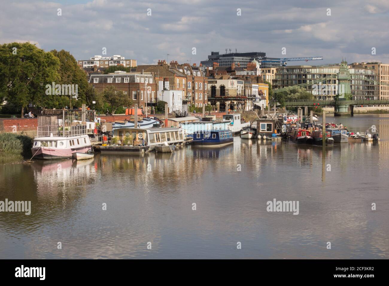 Houseboats moored on the River Thames by Furnival Gardens, Hammersmith, London, UK Stock Photo