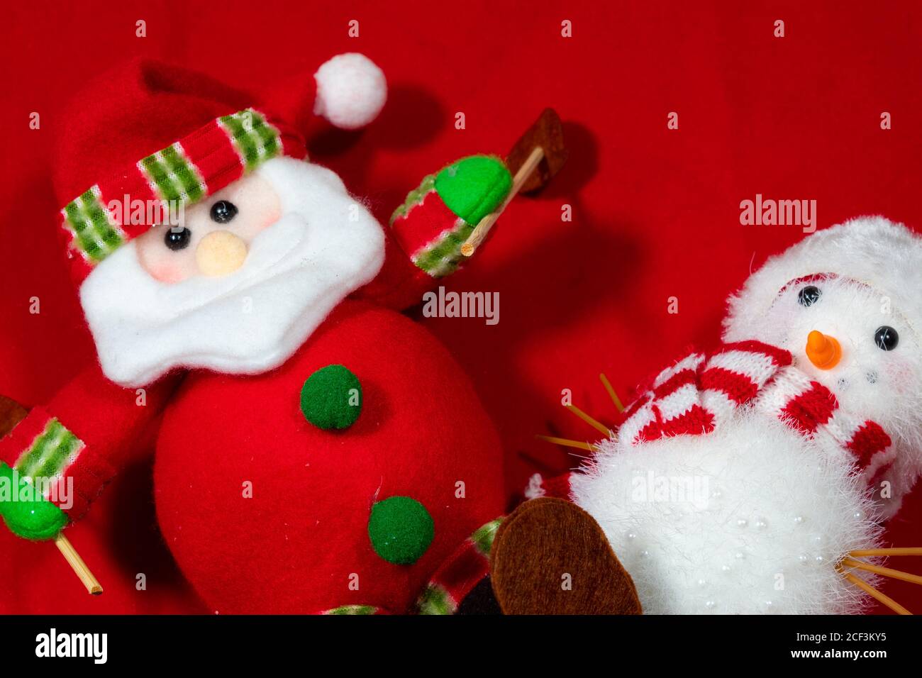 red christmas background with toy snow man and a santa claus, with ...