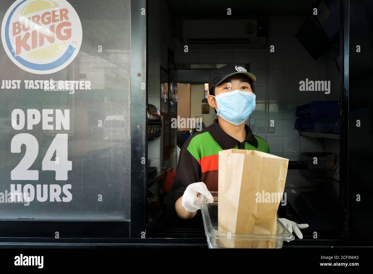 Bangkok, Thailand - September 3, 2020 : Burger King fast food cashier drive thru service wearing face mask to protect coronavirus pandemic or covid-19 Stock Photo