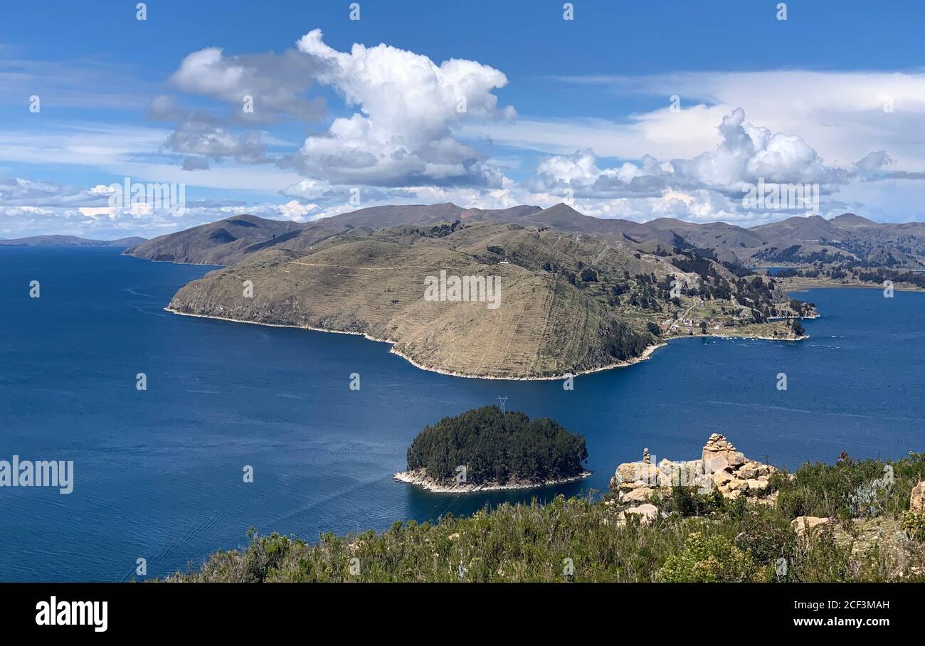View from the picturesque island of Isla del Sol, Bolivia, South America. Stunning Titicaca lake. Beautiful blue water and scenic cloudscape. Stock Photo