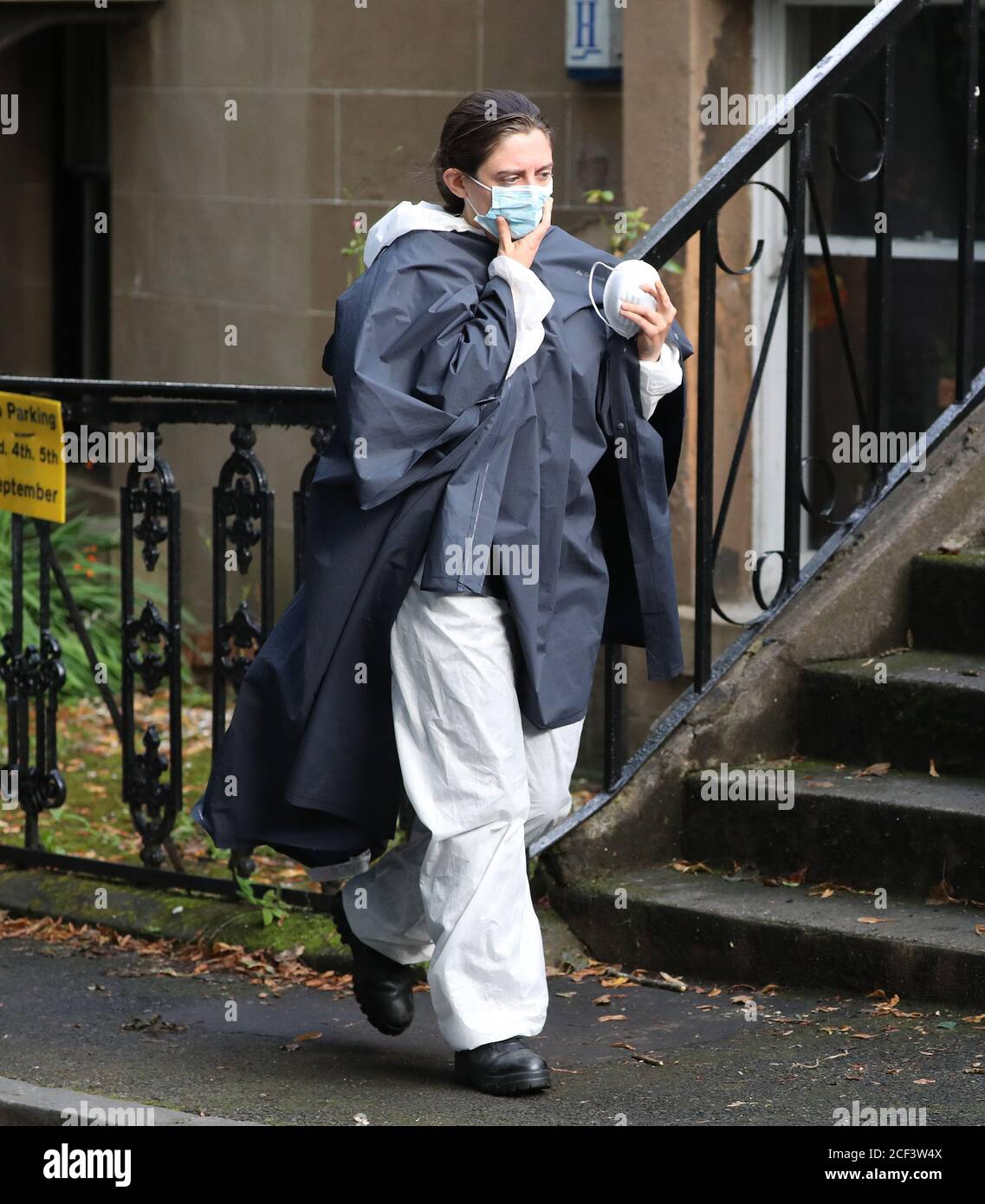 An actor wearing a white suit on the set of the new BBC thriller Vigil