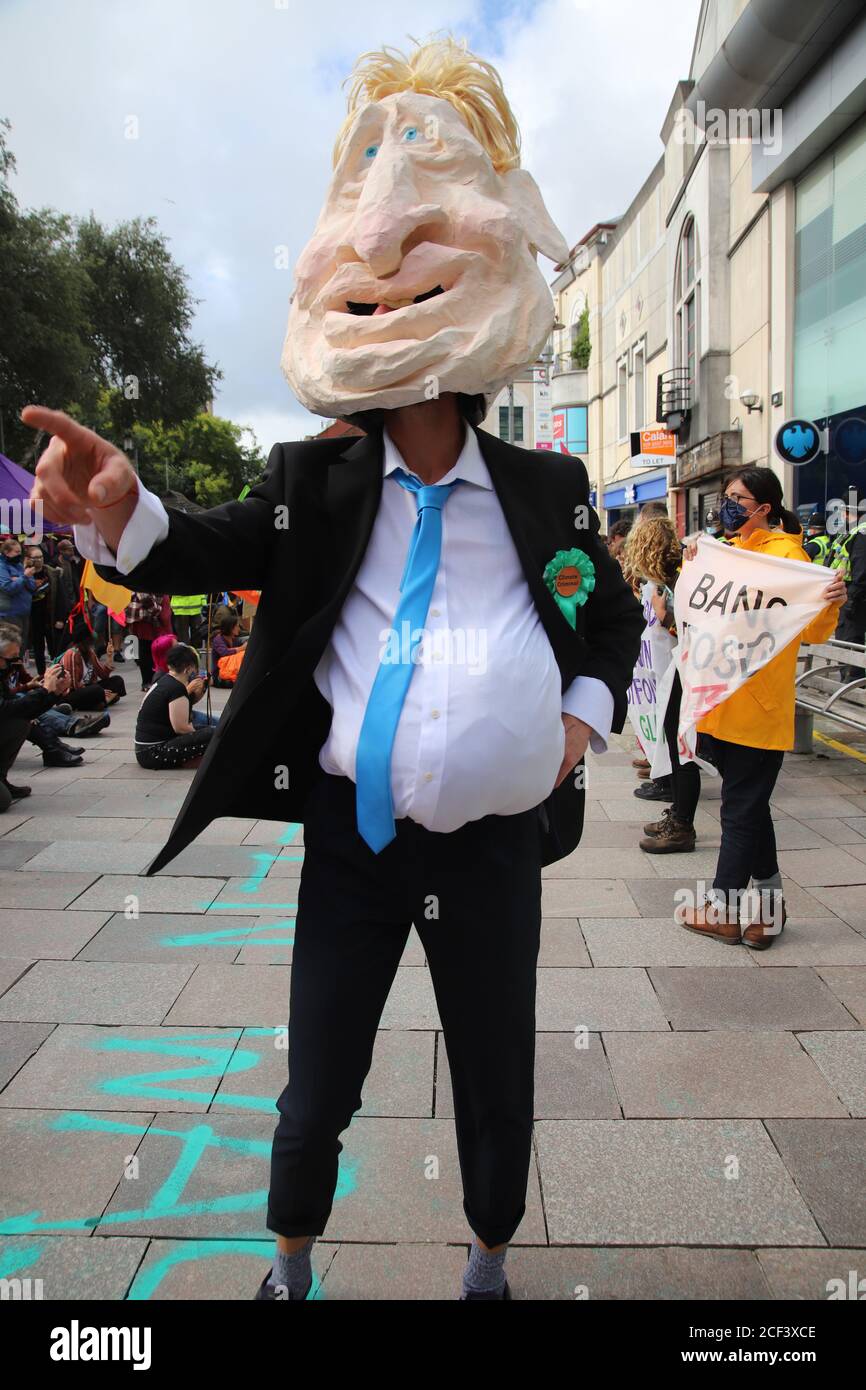 Cardiff, Wales, UK. 3rd Sep 2020. Extinction rebellion protesters outside Barclays Bank on the third day of actions in Cardiff, 3rd September 2020 as part of the Autumn uprising. Protesters highlight the banks investment in fossil fuel and its greenwashing policies. An effigy of Boris Johnson parades up and down outside the bank Credit: Denise Laura Baker/Alamy Live News Credit: Denise Laura Baker/Alamy Live News Stock Photo