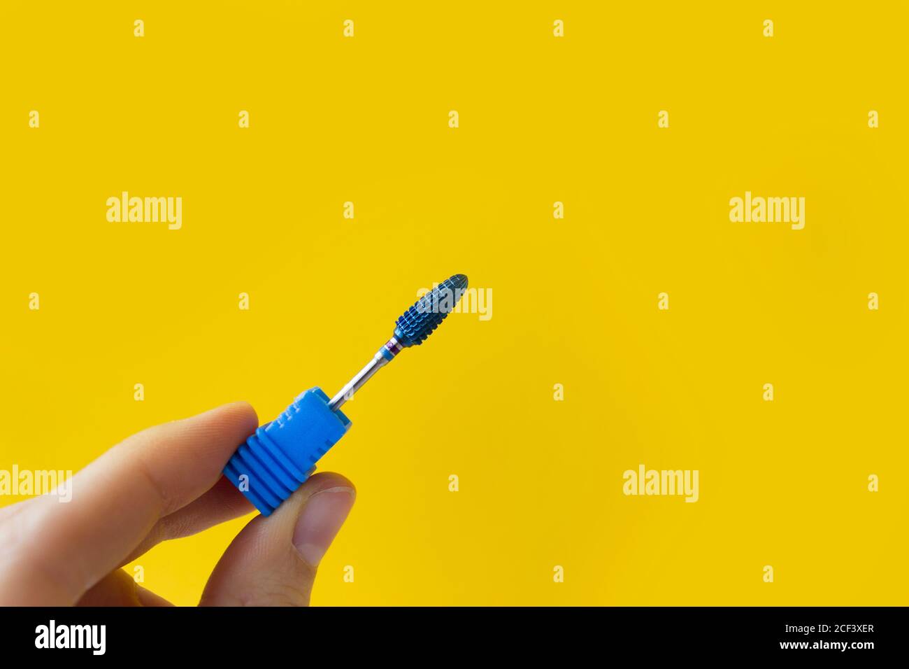 Nail Care Concept. Cutters for hardware manicure and pedicure on a yellow background. Stock Photo