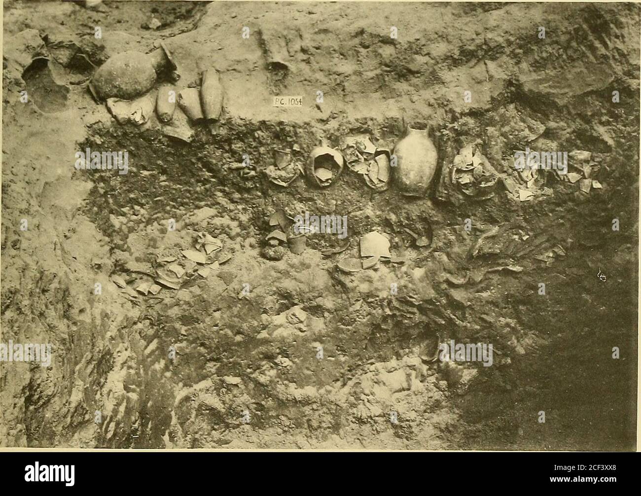 Ur Excavations Pg 1054 The Shaft A The Wooden Coffin Of Burial C The Right Hand End Broken Away To Expose The Interior H Section In The Shaft Showing Clay Vessels In Tiers