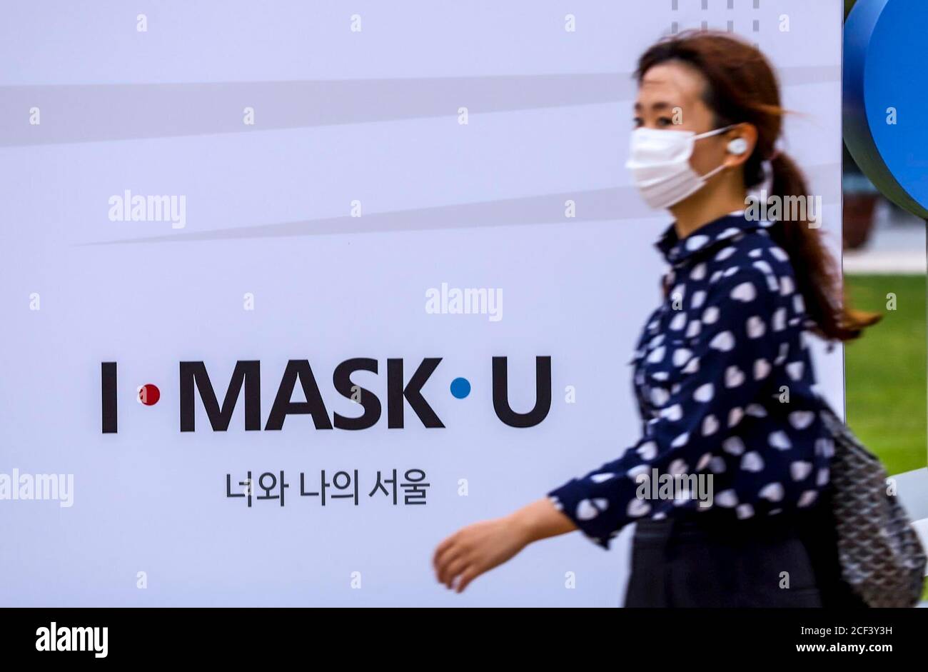 Seoul, South Korea. 3rd Sep, 2020. A visitor wearing a mask walks past in front of a slogan that reads I-MASK-U on the structure of Seoul City Hall Plaza. Credit: Won-Ki Min/ZUMA Wire/Alamy Live News Stock Photo
