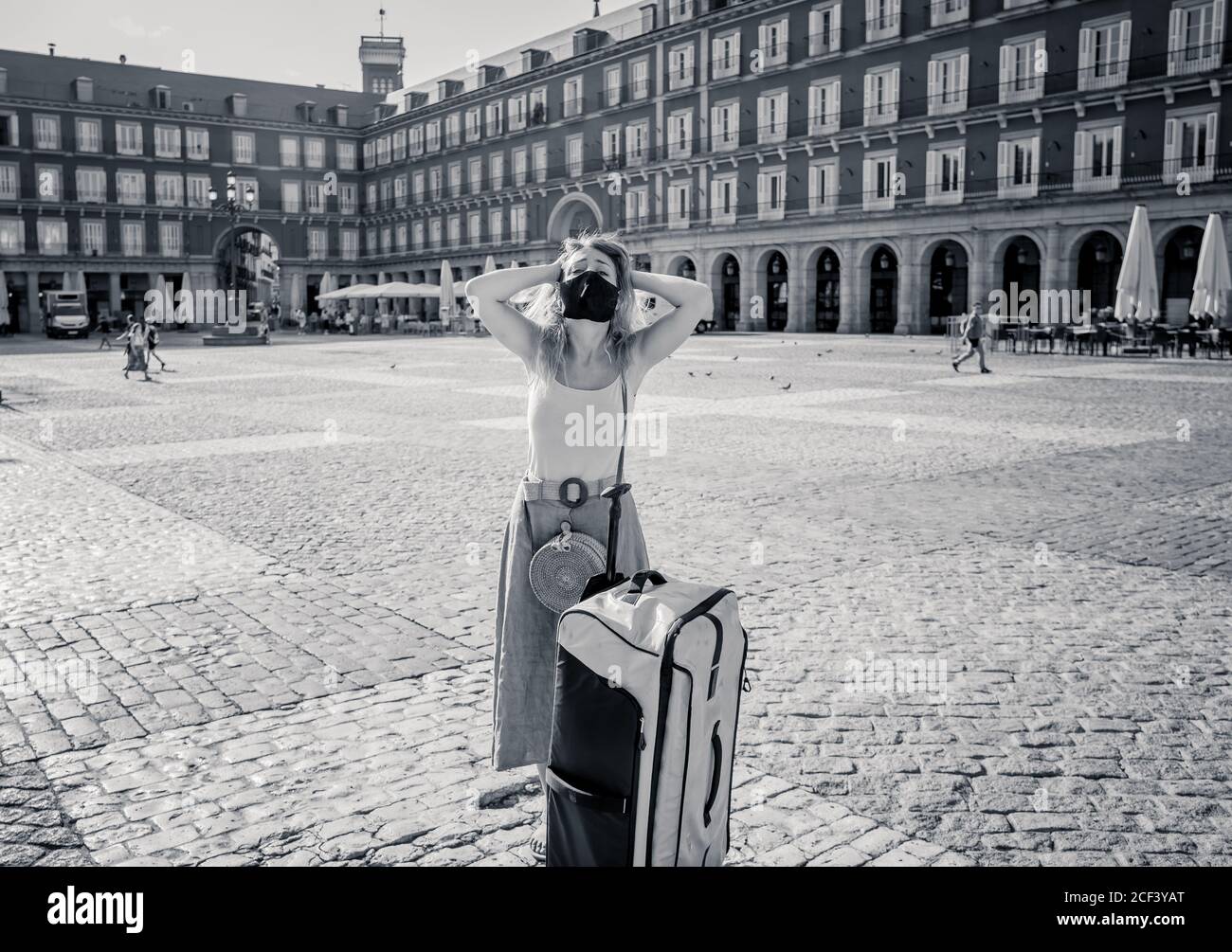 COVID-19 impact in tourism. Sad tourist wearing protective mask in Madrid Spain worried about coronavirus quarantine amid travel regulations. Vacation Stock Photo