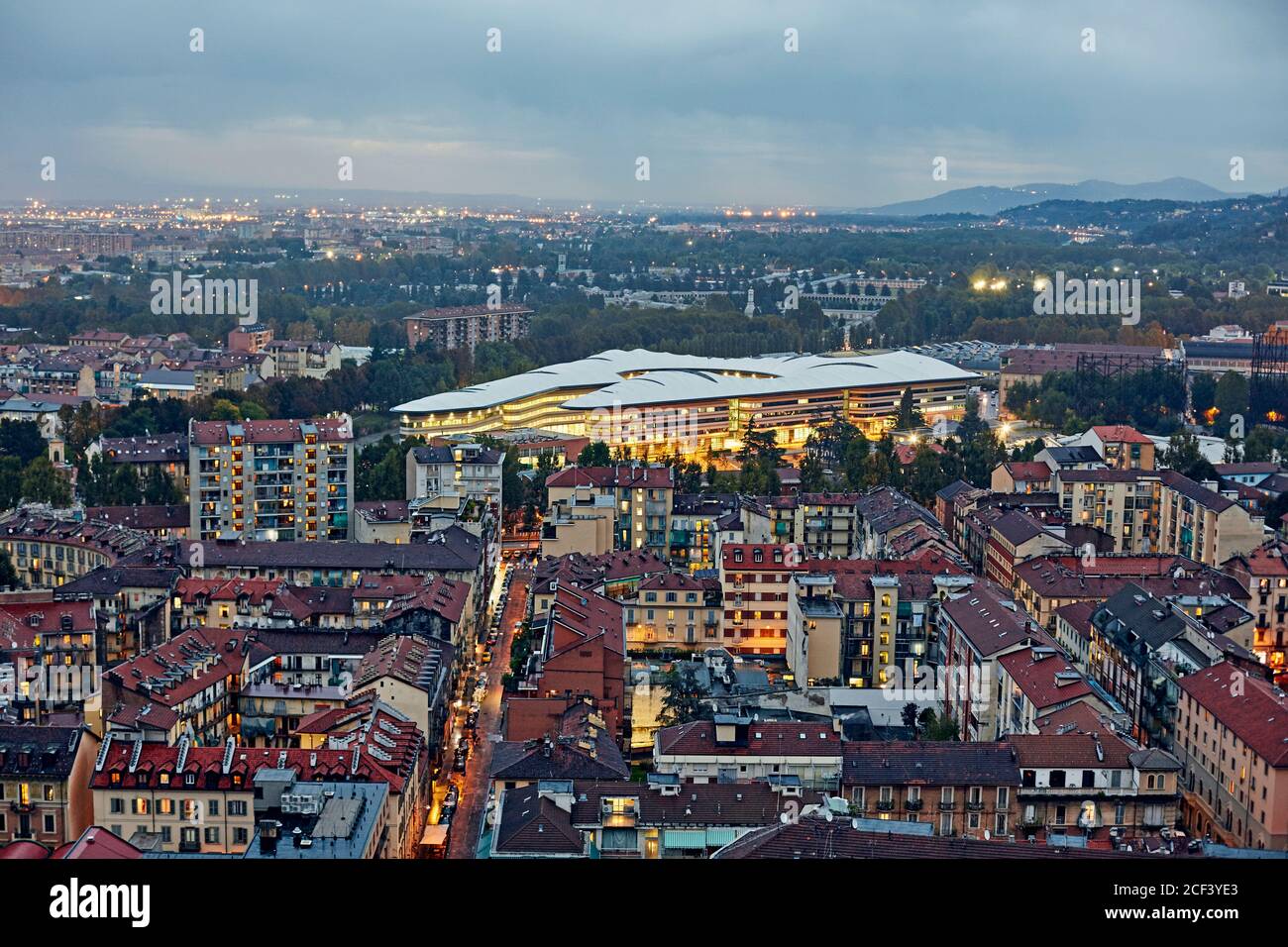 Aerial view of the skyline of Turin illuminated at dusk with Norman Foster designed Campus Stock Photo