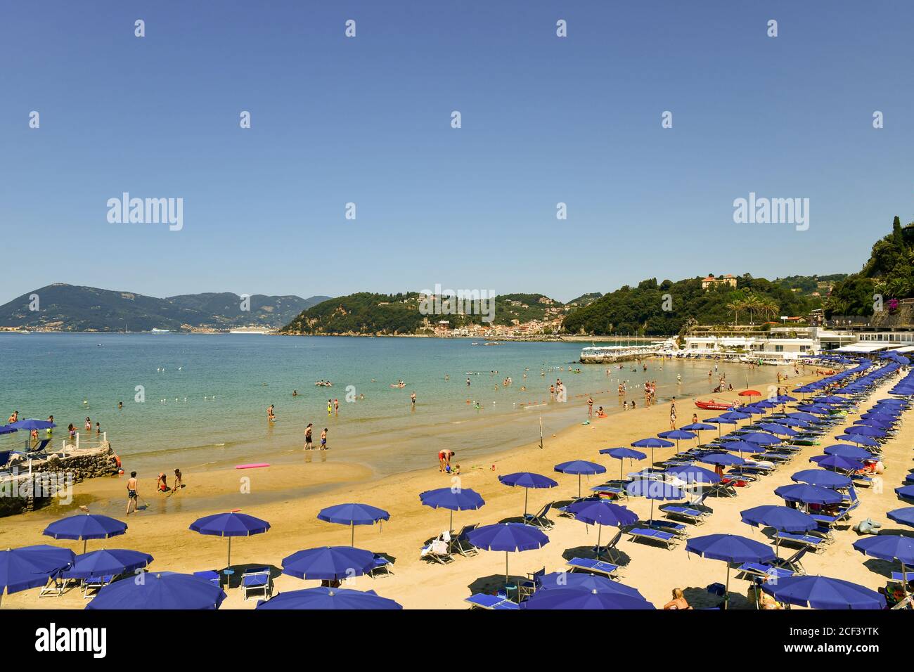 High angle view of a sandy beach with rows of sun umbrellas on the shore of the Gulf of Poets in a sunny summer day, Lerici, La Spezia, Liguria, Italy Stock Photo