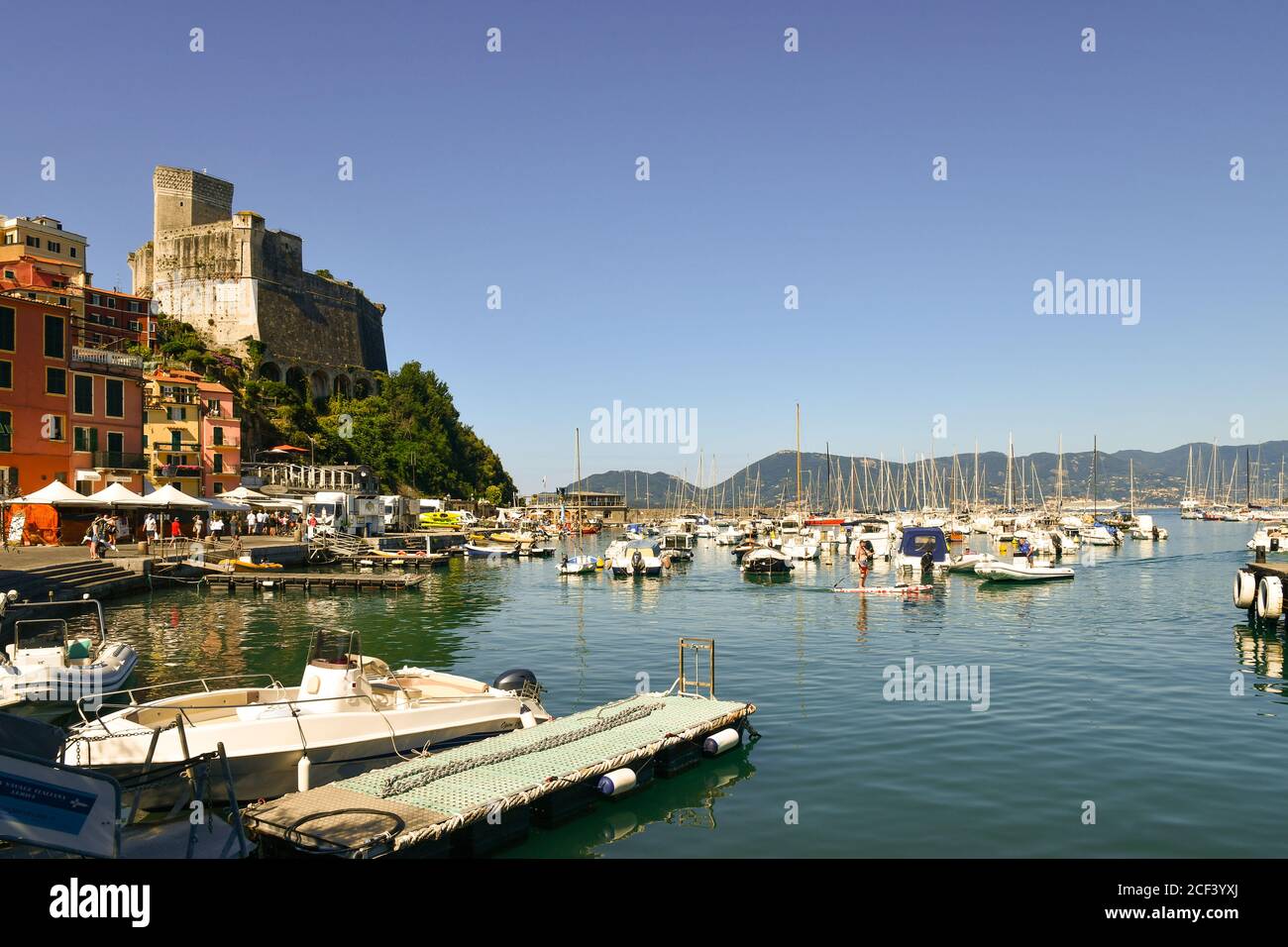 Scenic view of the harbor with the medieval castle overlooking the Gulf of Poets and the promontory of Porto Venere in the background, Lerici, Italy Stock Photo