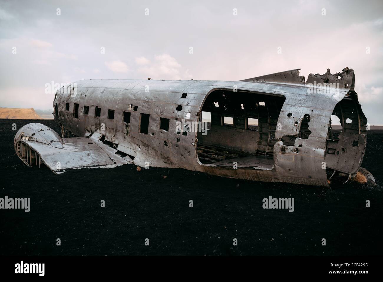 Damaged plane in desolated field Stock Photo