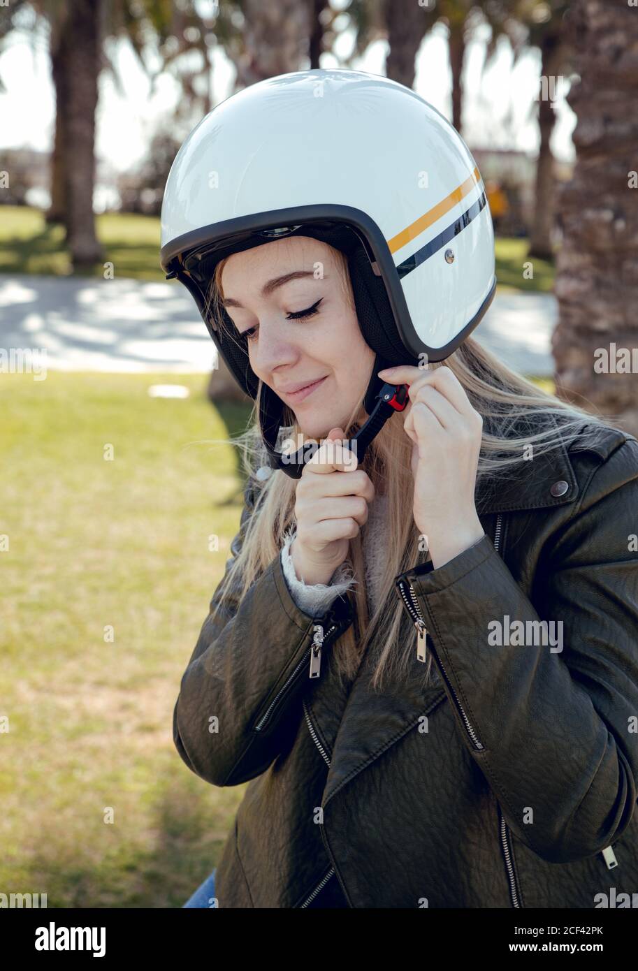 Woman adjusting helmet before hi-res stock photography and images - Alamy
