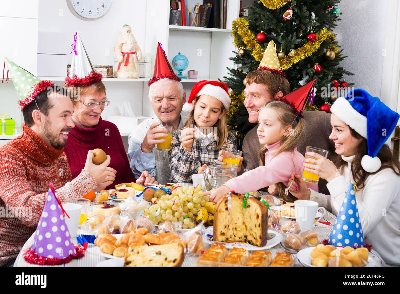 Large family members enjoying festive meal during Christmas dinner in