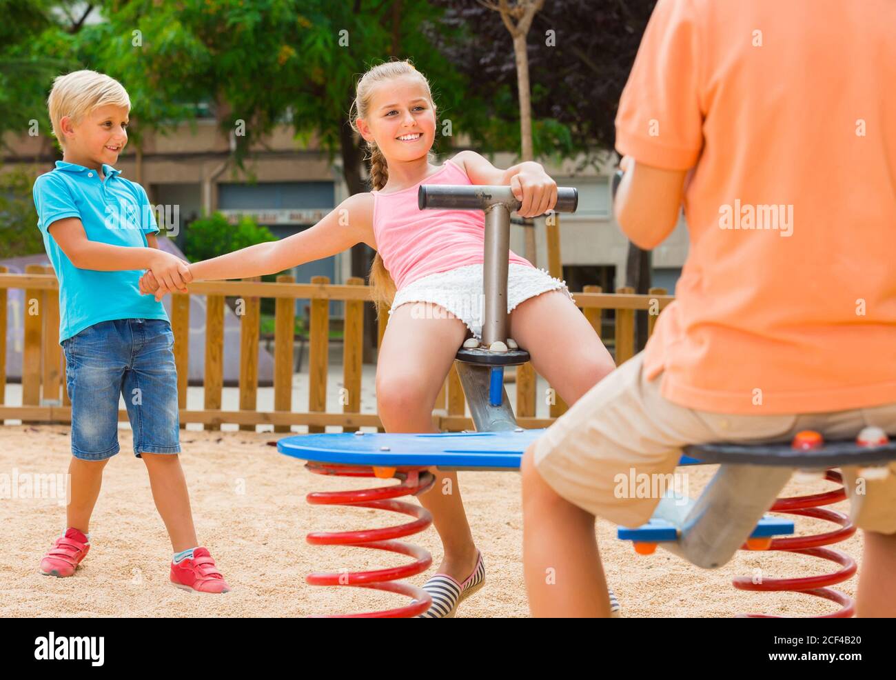 swiss preteens Positive swiss children are teetering on the swing in the playground Stock  Photo - Alamy
