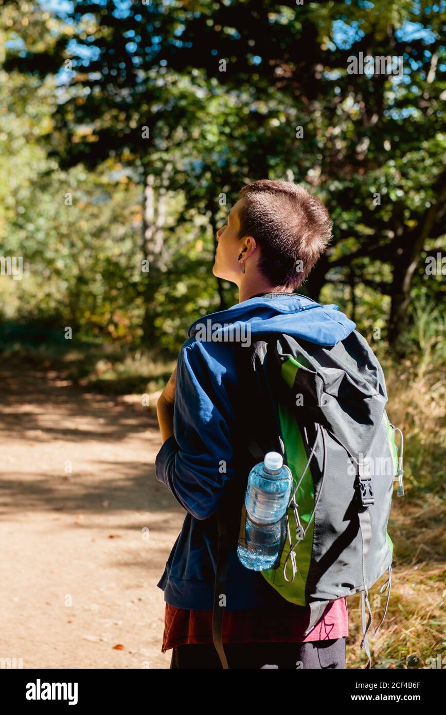 Crop anonymous chef burning gas stove with lighter before cooking in