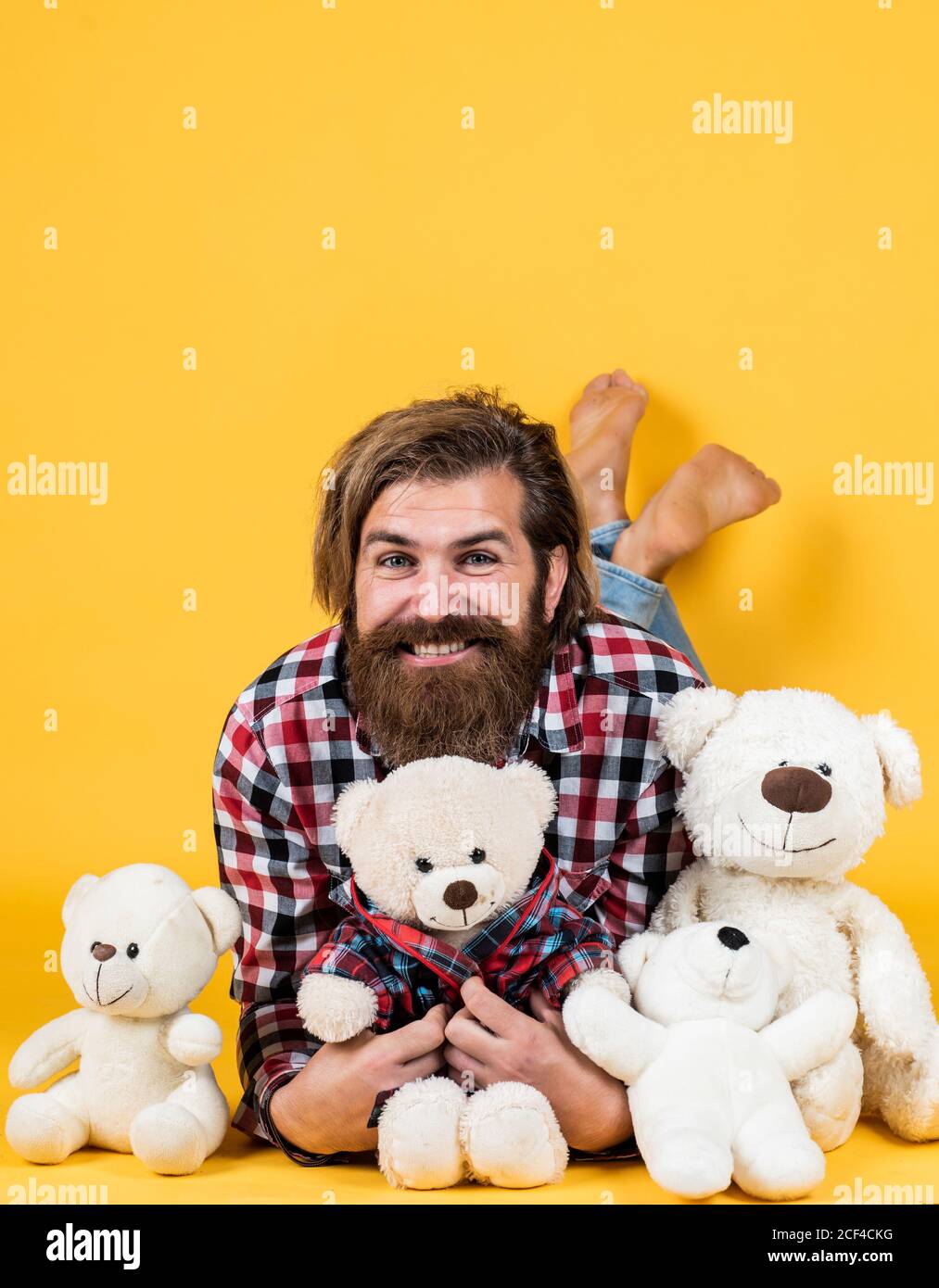 gift for her. Valentines day gift for beloved. Holiday celebration concept. Guy with happy face plays with soft toy. Childish mood concept. guy enjoy valentines day. best present ever. Stock Photo