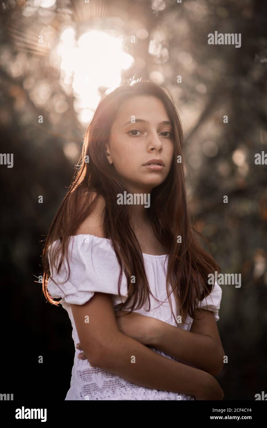 Side view of tender gorgeous young Woman in white dress embracing ...