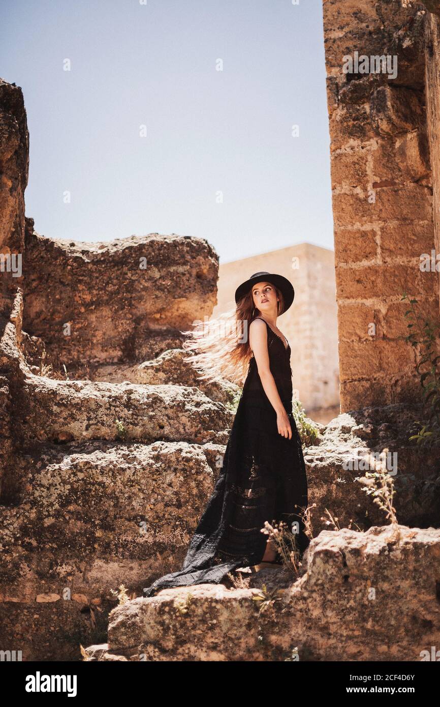 A woman with long elegant black dress hi-res stock photography and ...