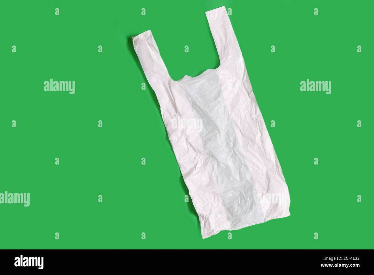 white plastic bag on green background Stock Photo Alamy