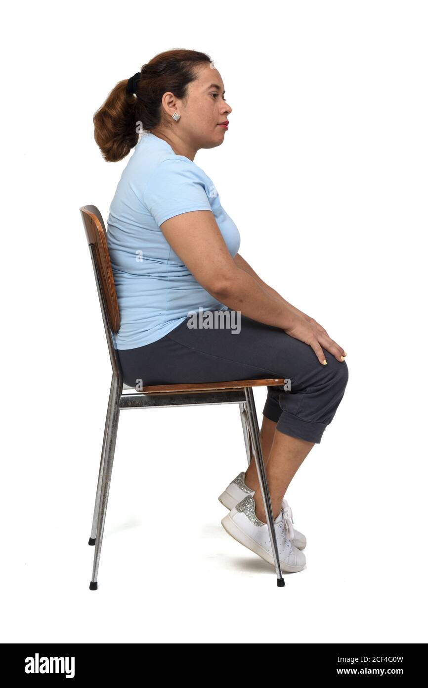 side view of a woman sitting on a chair look side on white background