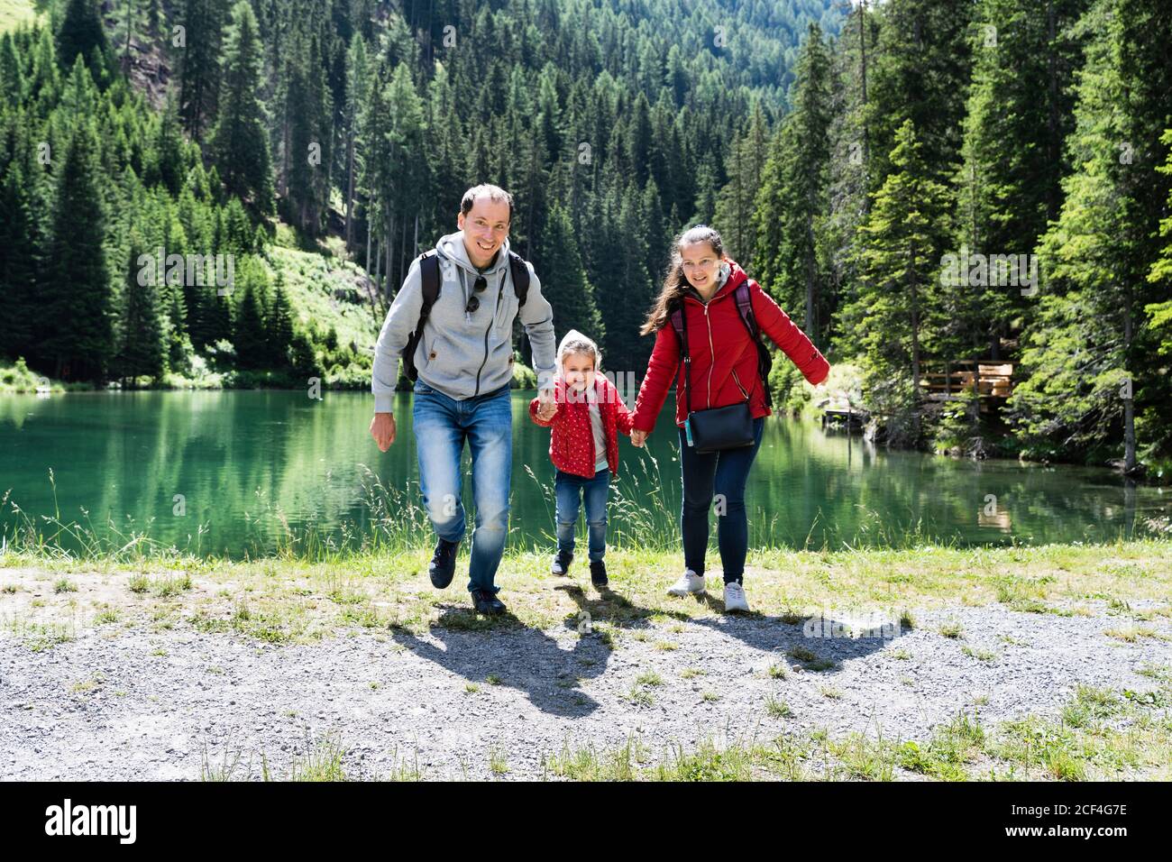 Family With Child Girl  At Mountain Lake In Austria Travel Stock Photo