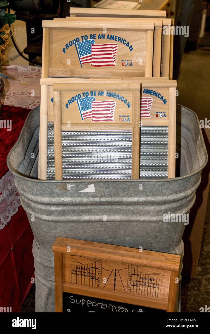Tub with washboards that will be sent to US servicemen in outlying posts where they must wash their clothes by hand. The kit includes a bucket, washboard, clothesline, pins and soap. Made by Columbus Washboard Co., Logan, Ohio. The company makes 88 different kinds of washboards. Stock Photo