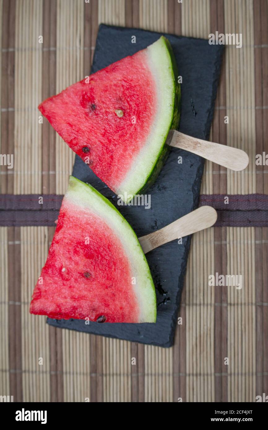 Watermelon slice on black stone plank, ice cream concept, selective focus Stock Photo