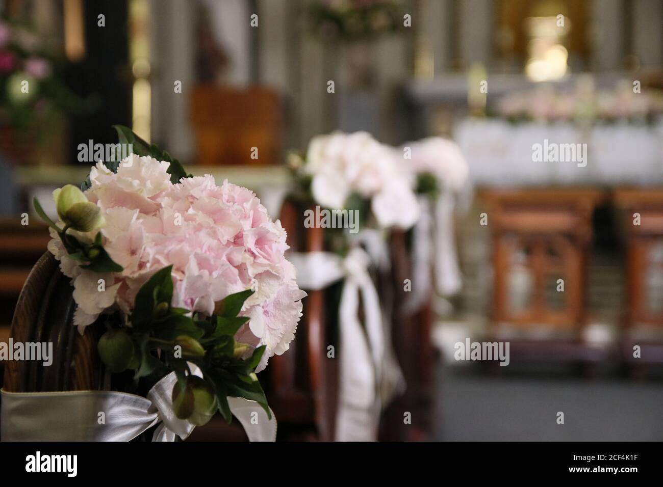 Interior of a catholic church, beautifully decorated with flowers for a wedding ceremony Stock