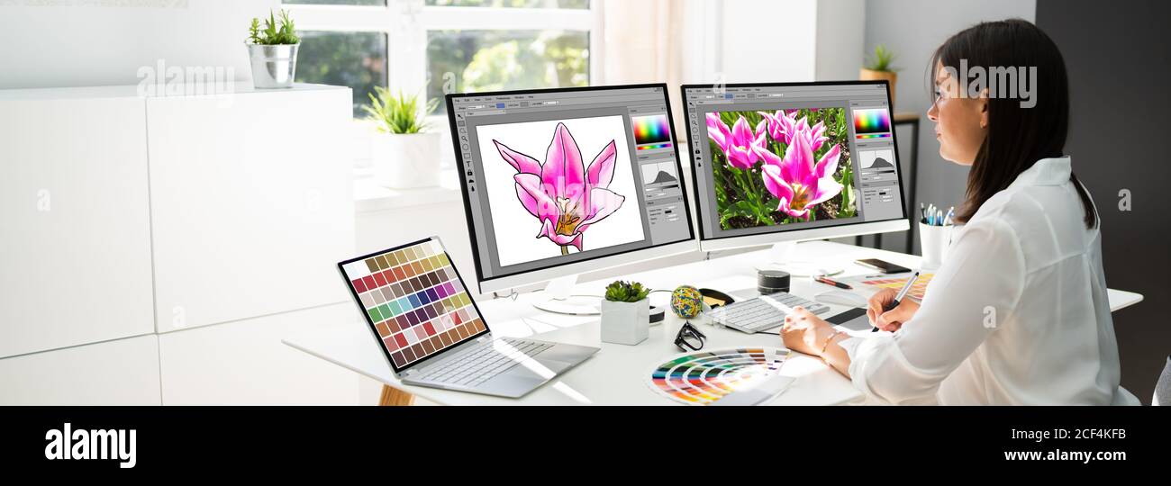 Graphic Designer Artist Working On Multiple Computer Screens Stock