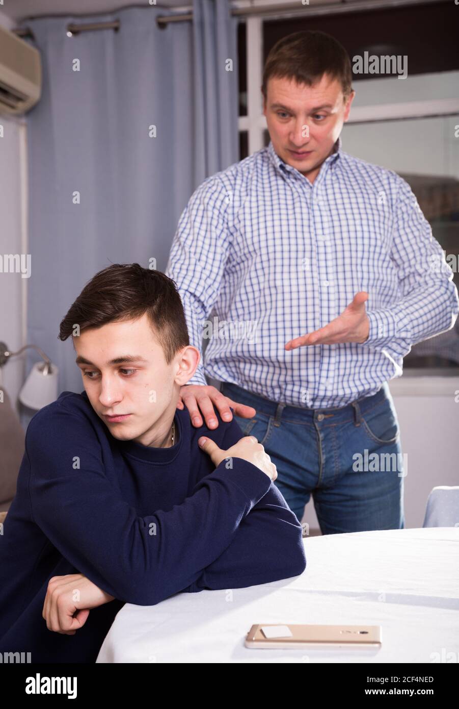 Boy is offended and father is asking for his forgiveness at the home ...