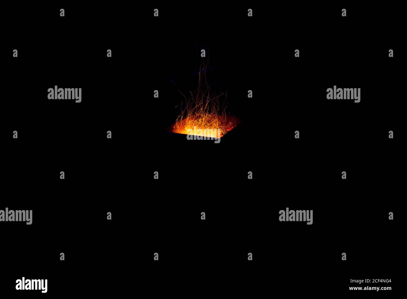 Burning sparks on exposure, black background Stock Photo