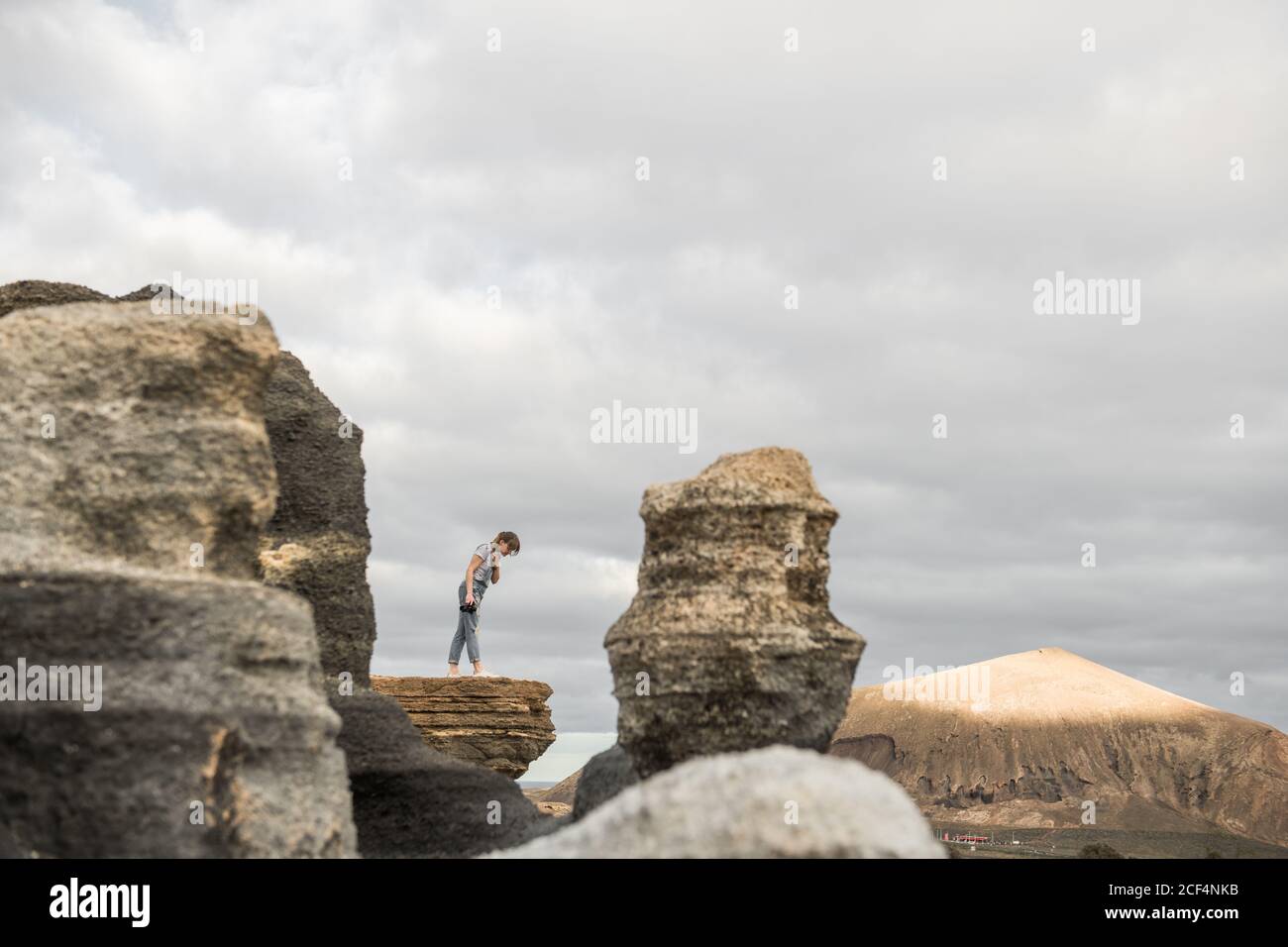 anonymous female taking pictures of stony terrain Stock Photo
