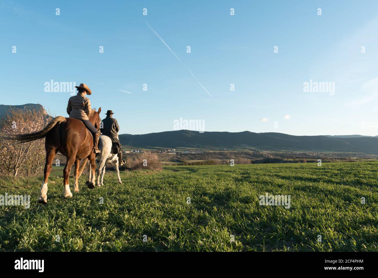 man and Woman riding horses on ranch Stock Photo