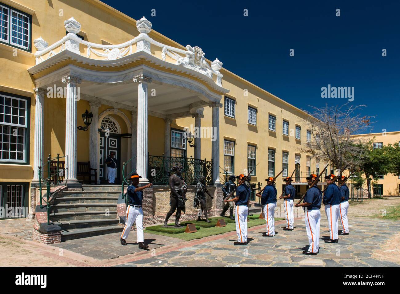 Soldiers perform the Key ceremony in front of the Governor's Residence and four statues, the “Kings of the Castle”, in Castle of Good Hope, Cape Town Stock Photo