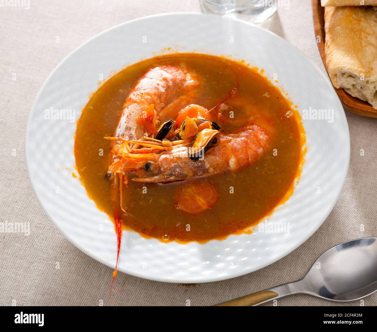 Spicy seafood broth with king prawns and shellfish Stock Photo Alamy