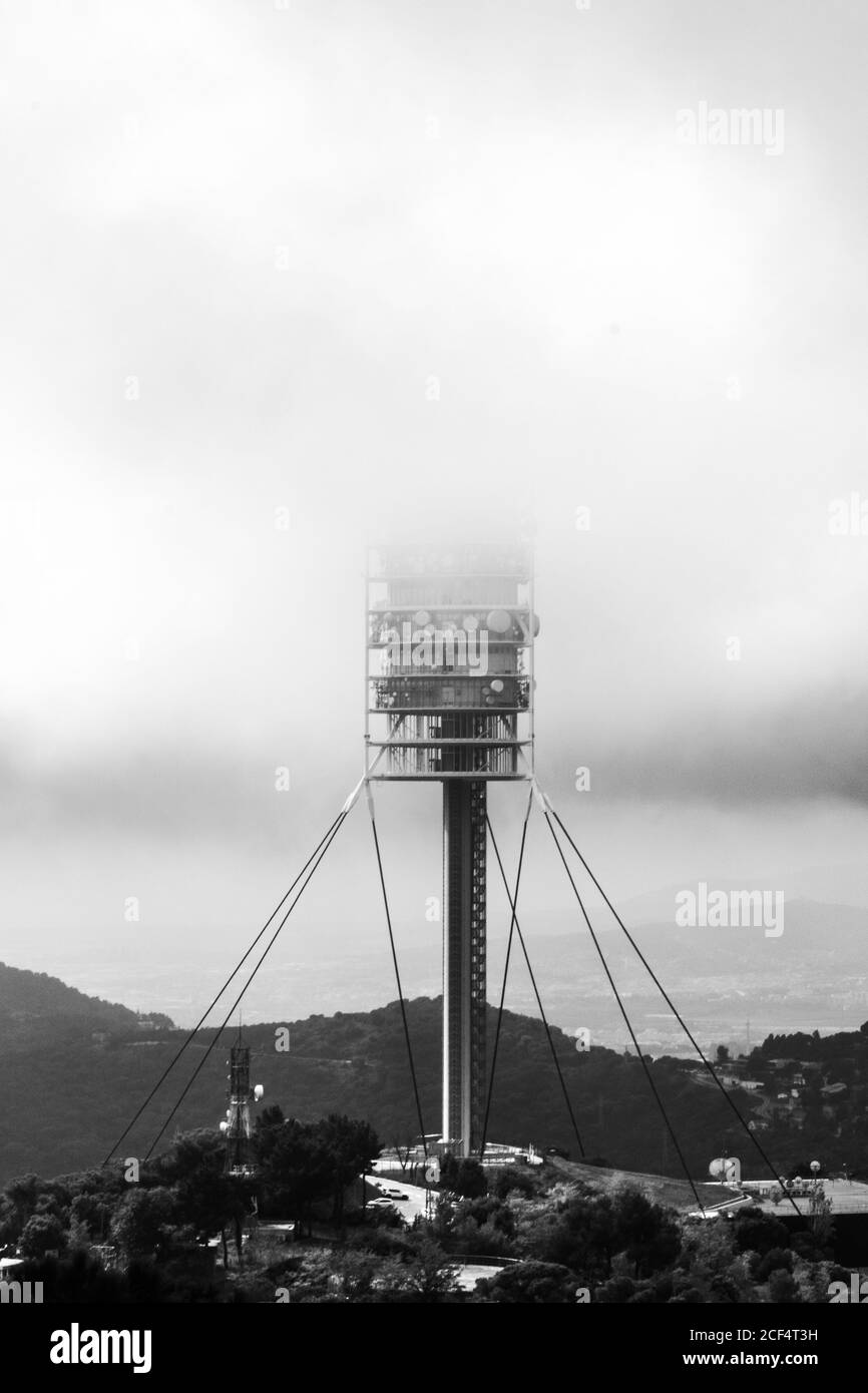 Landscape of TV tower Torre de Collserola with fog in Barcelona on cloudy day Stock Photo