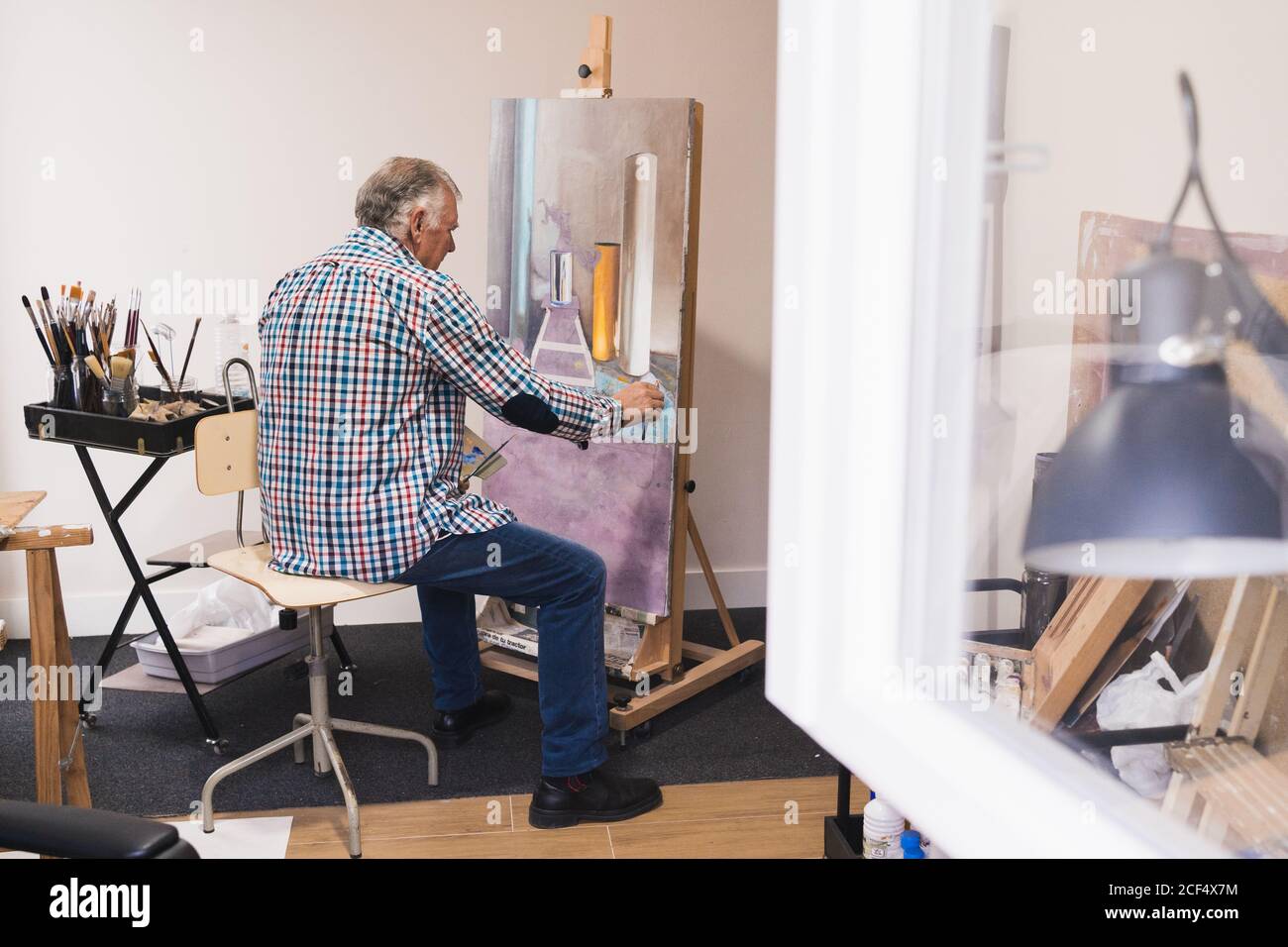 Man painting sitting table hi-res stock photography and images - Alamy