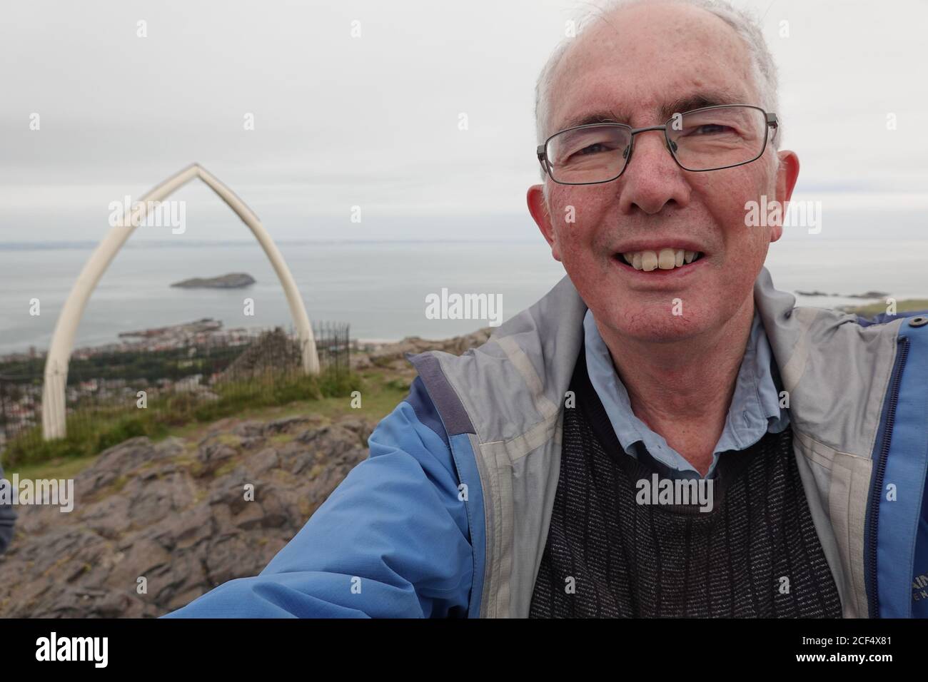 Man taking Selphy at top of North Berwick Law Stock Photo