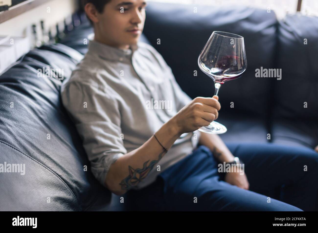 Skilled sommelier pouring wine. Man in 