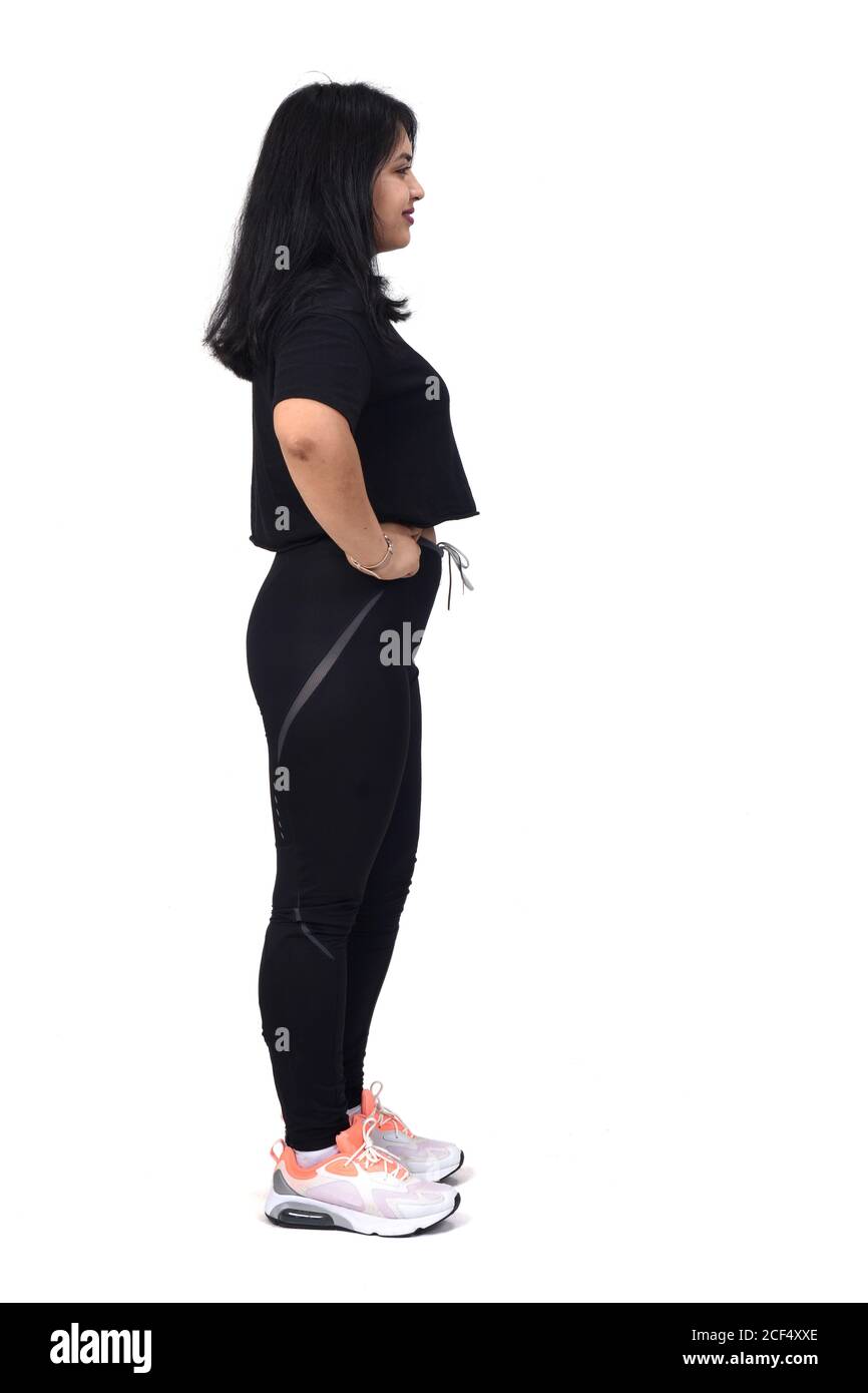 side view of a latin woman with sportswear looking at side on white