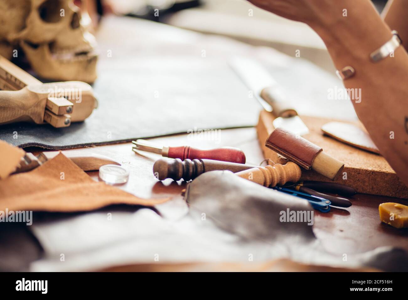Man working with leather using crafting DIY tools Stock Photo