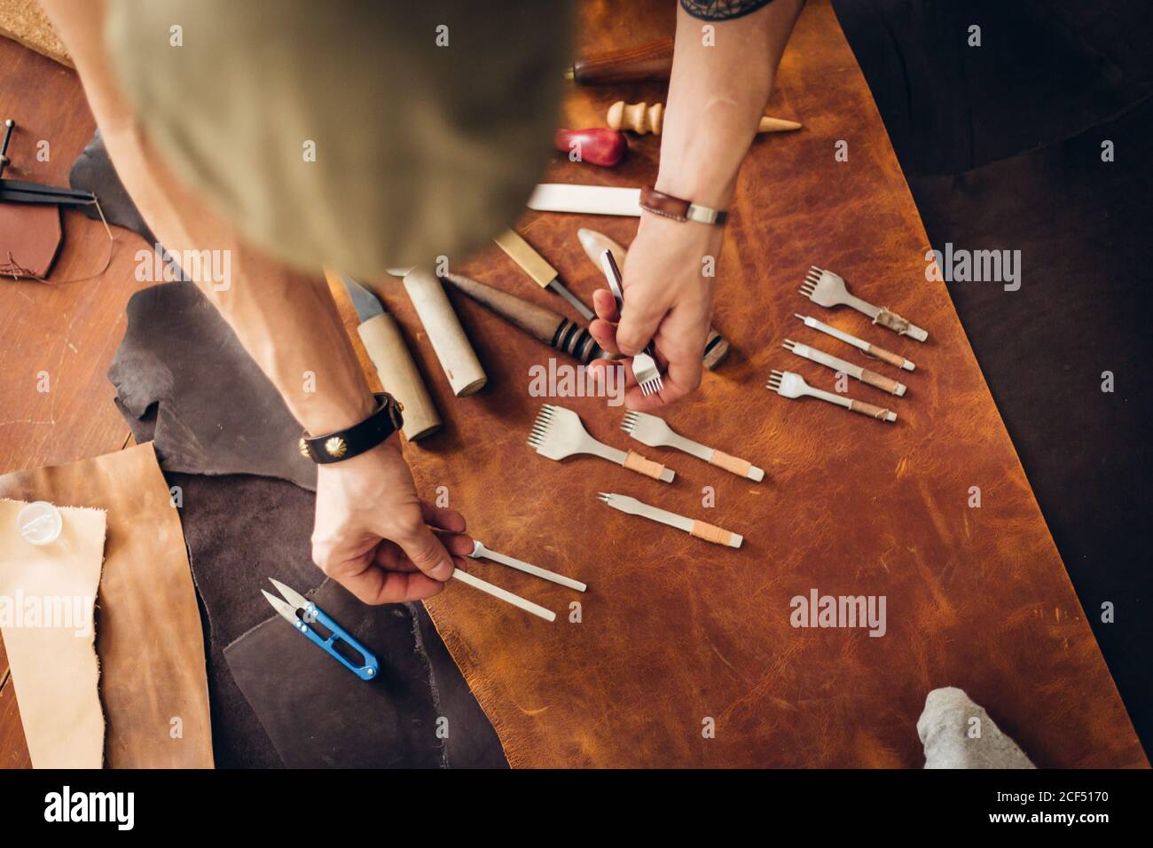 Leather craft. Leather and leather crafting tools on a work table Stock