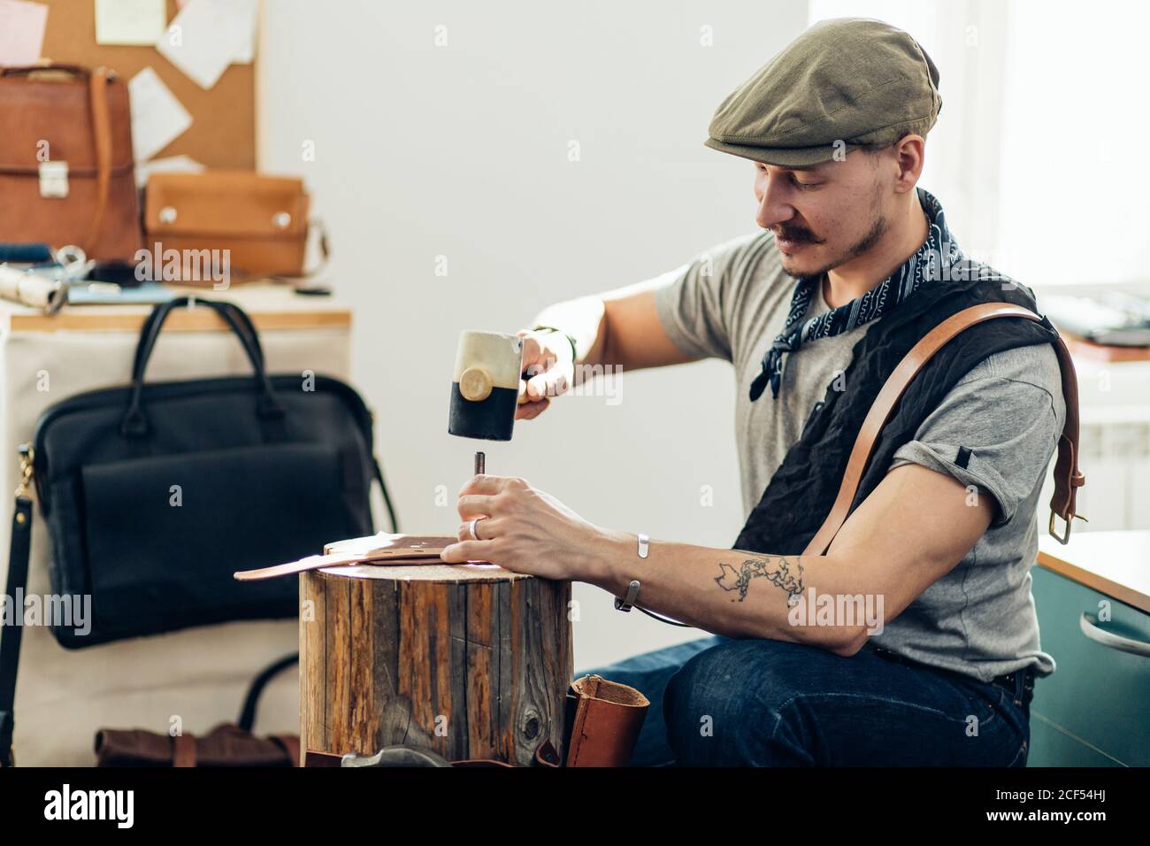 Man working with leather using crafting DIY tools Stock Photo