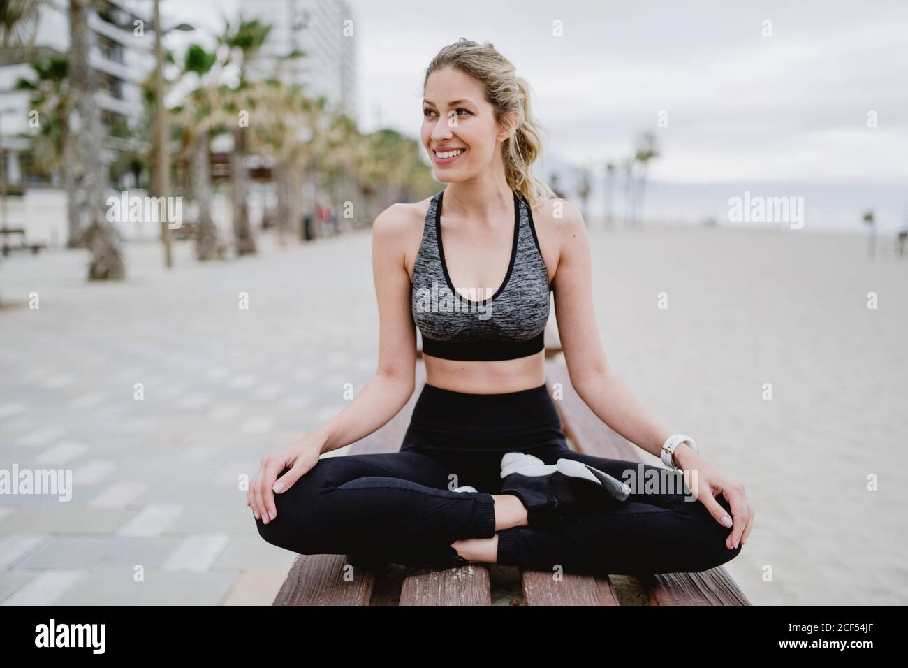 Woman stretching outdoors bench hi-res stock photography and