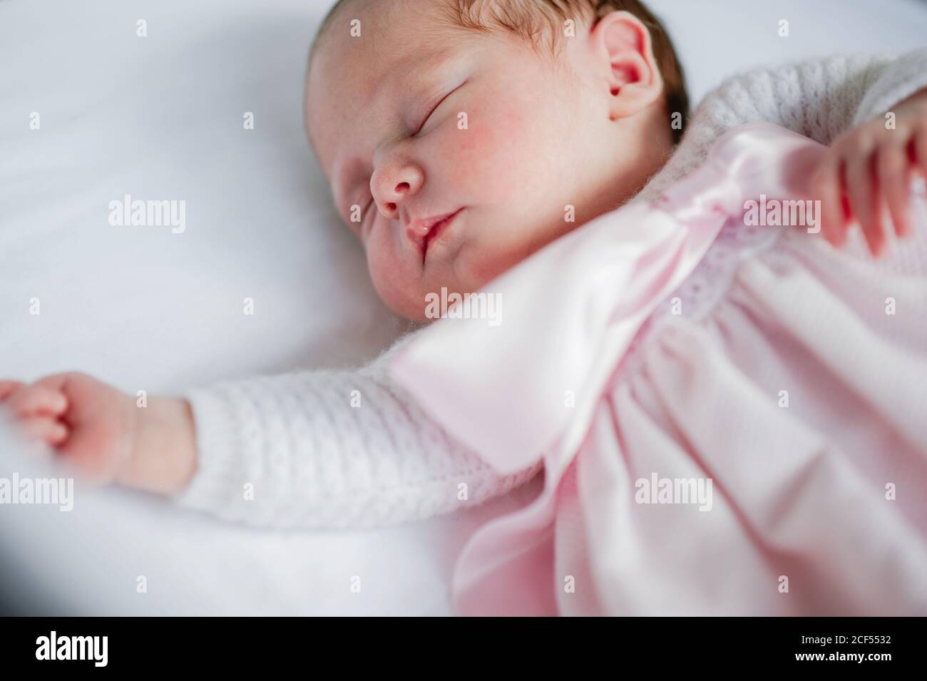 Baby girl lying in cot hi-res stock photography and images - Alamy
