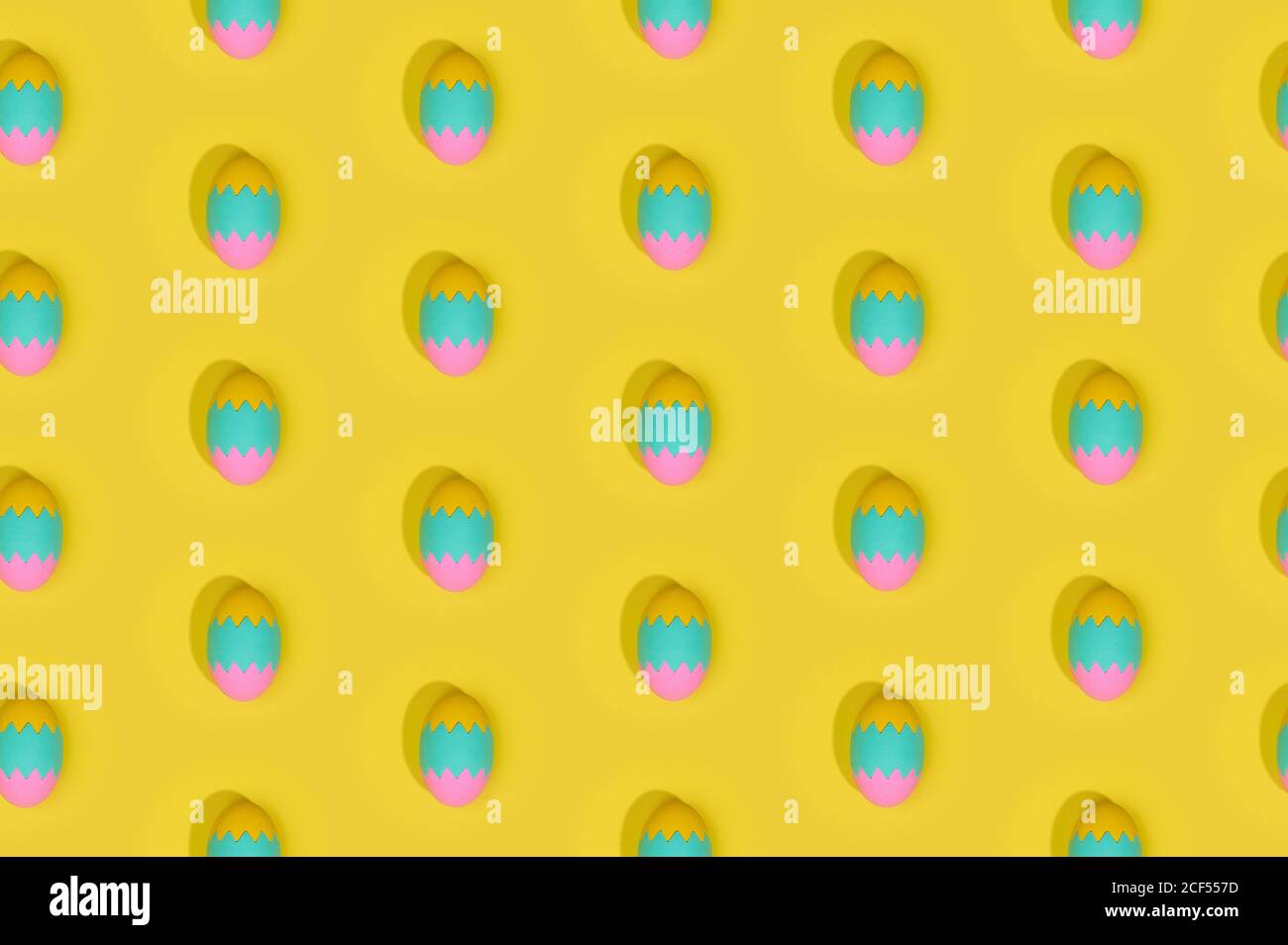 Seamless Easter pattern with colored decorated eggs arranged in rows on yellow background Stock Photo